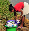 Soanierana Ivongo, Analanjirofo, Toamasina Province, Madagascar: woman washing clothes by the river - photo by M.Torres
