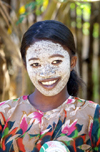 Andoany - Nosy Be / Be island, Antsiranana province, Madagascar: village girl with beauty mask - face cosmetic made from pounded roots of the Olax dissitiflora tree - mussiro - musiro - masonjoany - photo by R.Eime