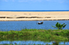 RN5, Mahatsara, Atsinanana region,Toamasina Province, Madagascar: beach and canoe - Indian Ocean inlet near the Onibe river estuary - photo by M.Torres
