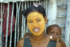 Morondava, Region of Menabe, province of Toliara, western Madagascar: Vezo woman and child - Sakalava Woman with Masonjoany cosmetic mask - photo by R.Eime