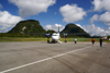 Mulu Airport, Sarawak, Borneo, Malaysia: MASwings Fokker F50 twin turboprop on the tarmac at MZV, gateway to Gunung Mulu National Park - 9M-MGB cn 20156 - karstic hills covered in vegetation in the background - photo by A.Ferrari