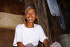 Skandis, Lubok Antu District, Sarawak, Borneo, Malaysia: Happy Iban man, inside the longhouse - Dayak people - photo by A.Ferrari