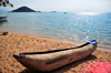 Cape Maclear / Chembe, Malawi: hand carved pirogue on the beach, Thumbi West Island and Mumbo Island on Lake Malawi National Park - photo by M.Torres