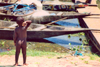 Mali - Segou: toddler looking at the boats in the port - photo by N.Cabana