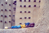 Djenn, Mopti Region, Mali: boy sleeping at the mosque - mud architecture - photo by N.Cabana