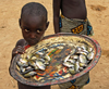 Djenn cercle, Mopti Region, Mali: boy selling river fish in village near Djenne - photo by J.Pemberton