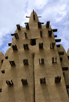 Djenn cercle, Mopti Region, Mali: tower of a mud brick Mosque in a village outside Djenne - deleb palm wood embedded in the adobe walls serves as scaffolding for repairs - Sahel Islamic architecture - photo by J.Pemberton