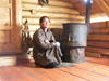 Mongolia - Arkhangai - Great White Lake / Terkhiin Tsagaan Nuur: woman at home by the stove - photo by P.Artus