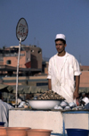 Morocco / Maroc - Marrakesh: Arab man selling snails as a snack - food stall at Place Djemaa el Fna - photo by F.Rigaud
