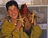 Tiznit - Morocco: country boy with chicken - poultry shop - photo by Sandia