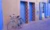 Tiznit - Morocco: bike and blue doors - photo by Sandia