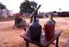 Ilha de Moambique / Mozambique island: 'gas station' - bottles of gasoline / bomba de gasolina - photo by F.Rigaud