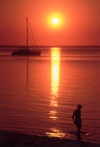 Mozambique / Moambique - Benguerra island / ilha, Vilanculos District, Inhambane province: sunset on the beach - yacht and woman silhouette / pr do sol na praia - photo by F.Rigaud