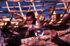 Ilha de Moambique / Mozambique island:  rapaz numa pilha de lenha (photo by Francisca Rigaud)