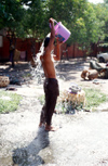 Myanmar - Mandalay: homeless man washes himself on the street - photo by W.Allgwer - Obdachlose haben einen der seltenen Hydranten angezapft und nutzen die Gelegenheit zum waschen. Das soziale Netz in Myanmar ist grobmaschig, weshalb viele hilfsbedrftig