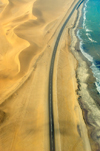 Namibia: Aerial view of Skeleton Coast with road - photo by B.Cain