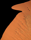 Namibia: Aerial view of half silhouetted sand dune from hot air balloon, Sossusvlei - photo by B.Cain