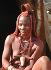 Namibia: Himba Woman sitting, Skeleton Coast, Kunene region - photo by B.Cain