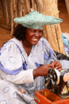 Kunene region, Namibia: Herero woman making souvenier dolls - Namibian hat - sewing machine - photo by Sandia