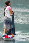 Pokhara, Nepal: young woman washing clothes in the lake - photo by E.Petitalot
