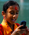 Pokhara, Nepal: a Nepali girl happy with her mobile phone - photo by E.Petitalot