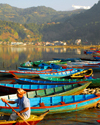Pokhara, Nepal: small boats on Phewa lake with Annapurna range in the background - photo by E.Petitalot