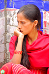 Kathmandu, Nepal: pensive young woman in red sari - photo by J.Pemberton