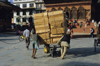 Kathmandu, Nepal: day labourers push a large load - Durbar square - photo by W.Allgwer