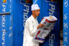 Bhaktapur / Bhadgaon, Bagmati zone, Nepal: man reading newspaper - photo lab - Konica - photo by J.Pemberton