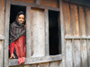 Annapurna region, Nepal: young woman at a window - photo by M.Wright