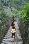 Annapurna region, Nepal: kids crossing a suspension bridge - photo by M.Wright
