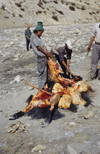 Annapurna area, Nepal: men cutting a slaughtered yak - photo by W.Allgwer