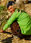 Sankhuwasabha District, Kosi Zone, Nepal: cat on the shoulder of a man weaving a bamboo mat - photo by E.Petitalot
