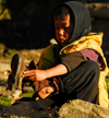Sankhuwasabha District, Kosi Zone, Nepal: boy with thorn socks puts on his shoes - photo by E.Petitalot