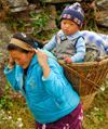 Sankhuwasabha District, Kosi Zone, Nepal: mother carrying a toodler in a bamboo basket - doko - photo by E.Petitalot