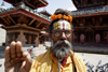 Kathmandu, Nepal: Sadhu with floral crown - Durbar Square - Hindu holy man - photo by G.Koelman