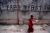 Kathmandu, Nepal: 'Free Tibet' graffiti and passing Tibetan monk - photo by G.Koelman