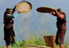 Nepal - Langtang region - two women use wind to separate grain and dust - photo by E.Petitalot