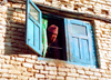 Nepal - Kathmandu valley: face in window - photo by G.Friedman