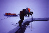 Arctic Ocean: Mark George negotiates a narrow crack - Arctic adventure - skiing - North Pole Expedition (photo by Eric Philips)
