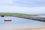 Orkney island, Mainland- View of the Churchill Barriers with a fishing vessel at anchor and aship wreck in the background. - photo by Carlton McEachern