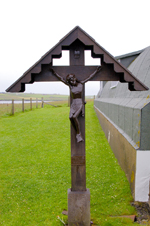 Scotland - Orkney - Lamb Holm island - the waysideshrine of the Italian Chapel. The carved figure of Christ was a gift fromthe Commune of Moena in Italy, Chiocchetti's home town - erected in 1961.The cross and canopy were made in Kirkwall - photo by Carlton McEachern
