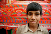 Peshawar, NWFP, Pakistan: portrait of a boy in front of a decorated truck - photo by G.Koelman