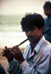 Karachi, Sindh, Pakistan: musical evening - man playing the flute on the beach - photo by R.Zafar