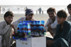 Karachi, Sindh, Pakistan: man selling toy airplanes on the beach - photo by R.Zafar
