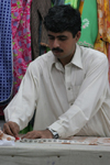 Karachi, Sindh, Pakistan: a young tailor at work - making clothes - photo by R.Zafar