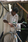 Karachi, Sindh, Pakistan: man repairing a bicycle - photo by R.Zafar