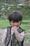 Jabbar, Siran Valley, North-West Frontier Province, Pakistan: little girl with fingers in her mouth - photo by R.Zafar