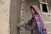 Kodar Bala, Siran Valley, North-West Frontier Province, Pakistan: old woman plastering a house - photo by R.Zafar