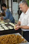 Hebron, West Bank, Palestine: local food vendor preparing sweets - photo by J.Pemberton